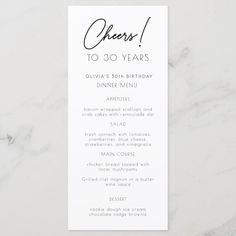 a white and black menu card with the words, cheers to 30 years on it