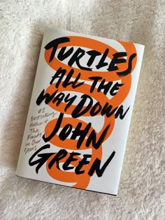 the book turtles all the way down by john green is laying on a white surface