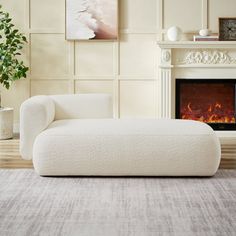 a living room with a white couch and fireplace