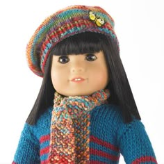 a doll wearing a knitted hat and scarf