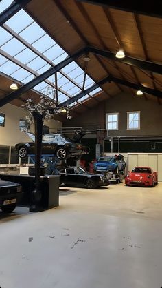 an indoor garage with several cars parked in it