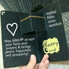 someone is holding up some cards with the words happy eid written on one side