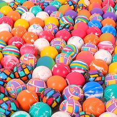 many different colored balls are stacked on top of each other in the same pattern and size