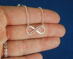 Sterling silver double infinity necklace, infinity knot, infinity symbol, bridal jewelry, sterling silver necklace, eternity necklace A double wire infinity link is attached to a sterling silver chain that can be any length up to 22 inches in length and is secured with a sterling silver lobster claw clasp. You can choose between the small, medium, and large infinity links. The small infinity measures 0.55 x 0.26 inches (14 x 6.5mm). The medium infinity measures 0.79 x 0.37 inches (20 x 9.5mm). T Sterling Silver Infinity Necklace With Adjustable Chain, Silver Infinity Necklace With Delicate Chain, Silver Infinity Jewelry, Silver Infinity Necklaces For Wedding, Silver Infinity Necklace For Wedding, Silver Infinity Necklace In Dainty Style, Silver Infinity Dainty Necklace, Silver Dainty Infinity Necklace, Dainty Silver Infinity Necklace