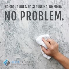 a hand holding a white towel on top of a marble wall with the words, no grout lines, no scrubbing no mold