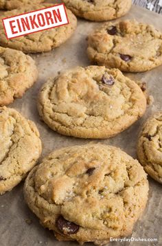 chocolate chip cookies with the word enkorn above them on a baking sheet lined with parchment paper