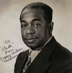 a black and white photo of a man in a suit