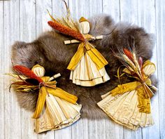 an arrangement of decorative items made out of paper on a fur rug with corn stalks in the center