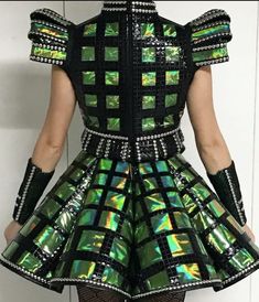 the back of a woman's dress with green and black designs