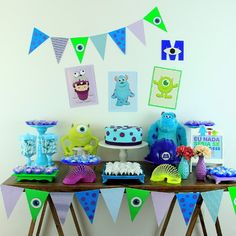 a table topped with cake and cupcakes covered in decorations