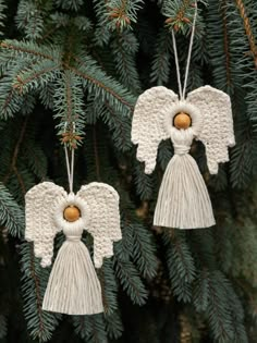 two crocheted angel ornaments hanging from a tree