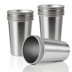 several stainless steel cups stacked on top of each other with one empty cup in the middle