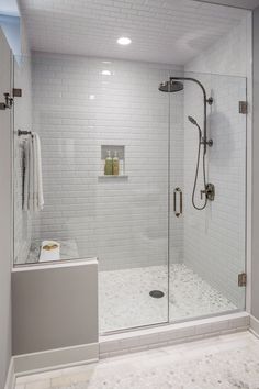 a bathroom with a walk in shower next to a white sink and bathtub area