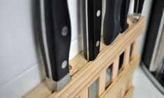 several knives are mounted on a wooden holder