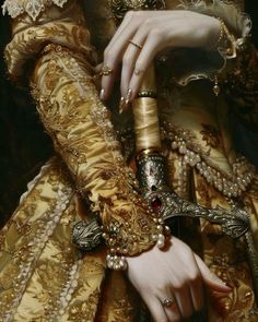 a close up of a woman's hand with jewelry on her arm and bracelet