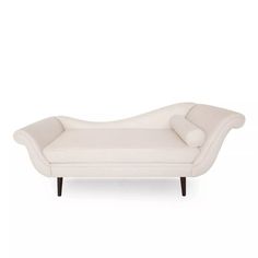 a white couch sitting on top of a wooden table