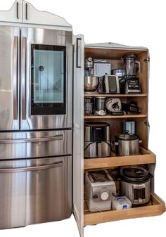 a stainless steel refrigerator with shelves full of appliances