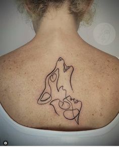 a woman with a tattoo on her back that has a dog and cat in it