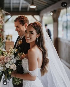 the bride and groom are walking down the aisle at their wedding ceremony in an old train station