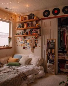 a bedroom with a bed, bookshelf and record player on the wall above it