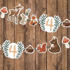 the number four is surrounded by forest animals and leaves on a wooden background with wood planks