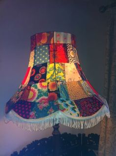 a lamp that is sitting on top of a table with a cloth shade over it