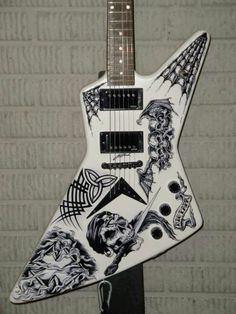 an electric guitar with tattoos on it