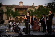 a group of people that are standing on a stage with musical instruments in front of them