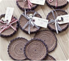 wooden slices with ribbons tied around them on the floor next to tags that say, little bites