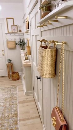 a purse hanging on the wall next to a shelf with some baskets and other items