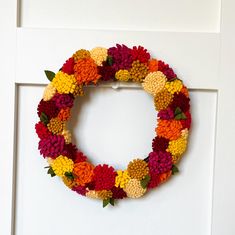 a wreath made out of crocheted flowers on a door