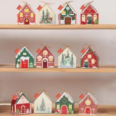 a shelf filled with lots of small houses on top of wooden shelves covered in christmas decorations