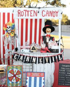 a carnival booth with skeleton decorations and candy