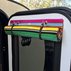 an open door with colorful stripes on it and the word papaa hanging from the side