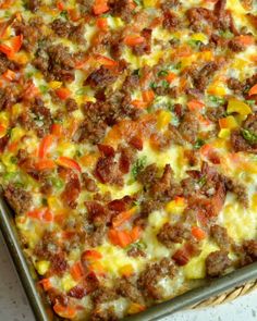 a casserole dish with meat, cheese and vegetables