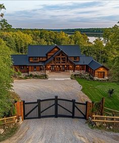 an aerial view of a large home with a driveway and gate leading into the front yard