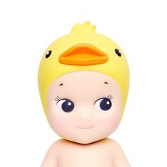 a yellow rubber ducky toy sitting on top of a white surface with blue eyes