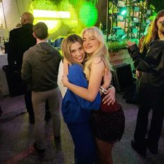 two women hugging each other at a party