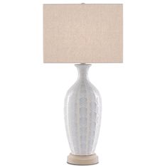 a white table lamp with a beige shade