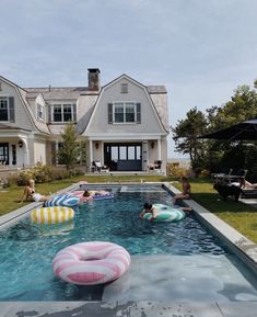 people are in the swimming pool with floats