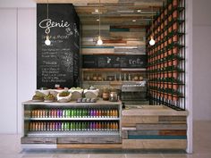 an open counter with lots of bottles and condiments in front of a chalkboard wall