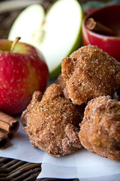 apples, cinnamon sticks and apple cider are on the table next to an apple