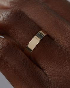 a woman's hand with a gold ring on it