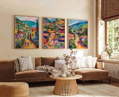 a living room with two paintings on the wall