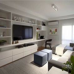 a living room filled with furniture and a flat screen tv on top of a wall