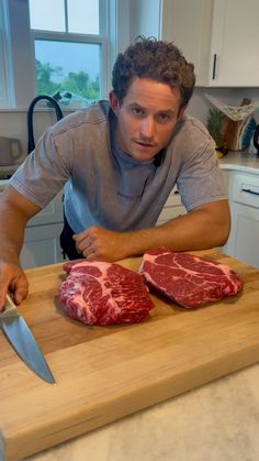 a man cutting up some meat on top of a wooden counter next to a knife