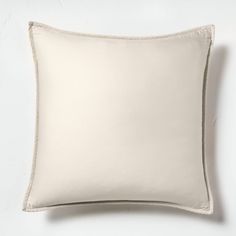 a white pillow on a white wall