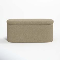 an upholstered storage ottoman in light brown fabric, on a white background with room for text