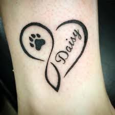 a dog paw and heart tattoo with the word paws written on it's side