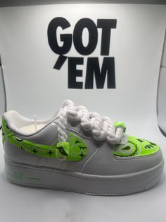 the nike air force 1 is decorated with neon green and white laces, which are accented with flowers